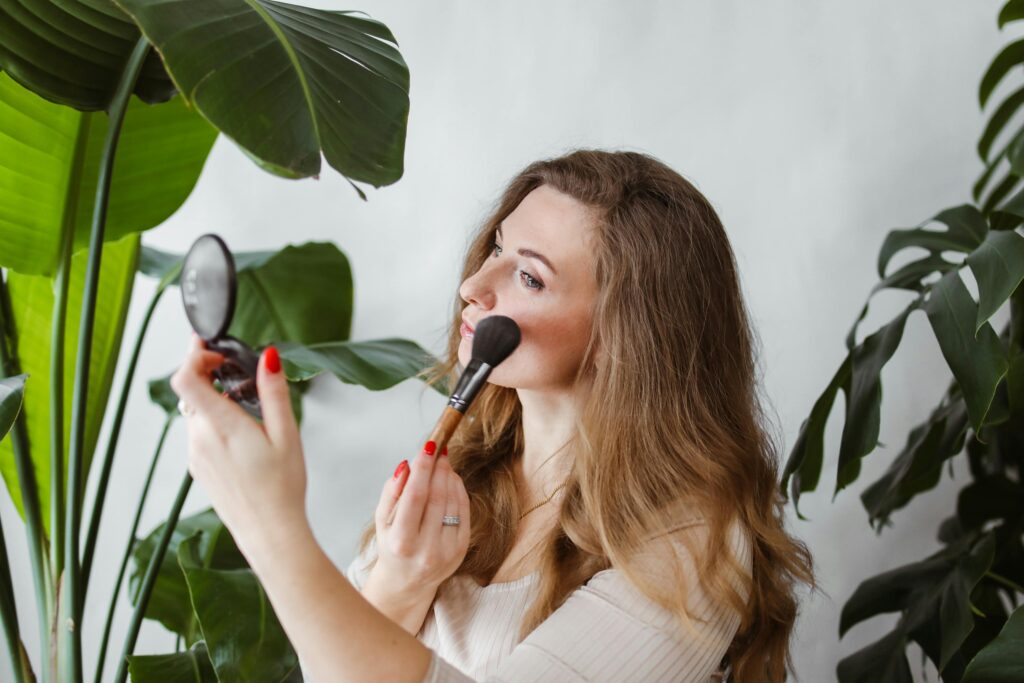  Woman applying makeup in front of a mirror 